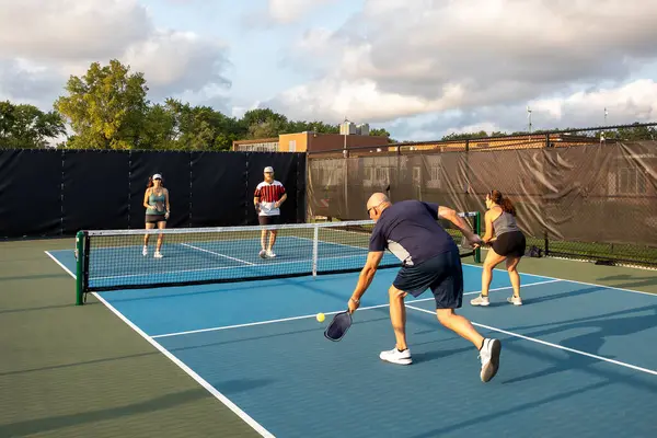 Four Pickleball Players Rally Each Other One Attempts Return Shot Stock Photo