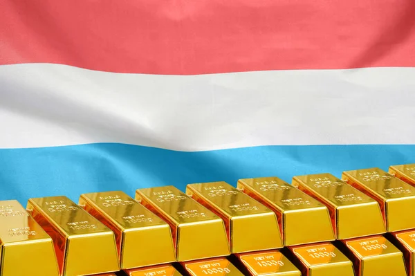 Row of shining golden bullions on the Luxembourg flag background. Business and financial countrys reserves. Concept of gold reserve and gold fund of Luxembourg