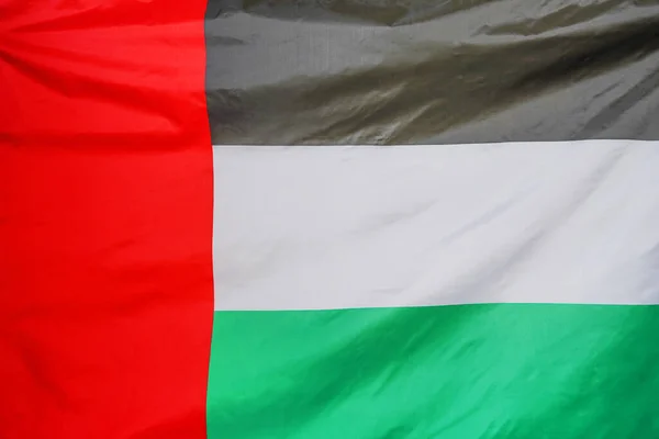 Fabric texture Flag of United Arab Emirates. Flag of United Arab Emirates waving in the wind. Flag of United Arab Emirates is depicted on a sports cloth fabric with many folds. Sport team banner