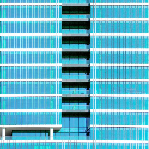 Glass blue windows of facade modern city business building skyscraper. Building window texture