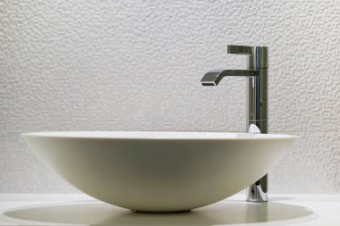 Interior of bathroom with washbasin and faucet. Public bathroom in the airport or restaurant, cafe, office. Bathroom interior sink with modern design in hotel