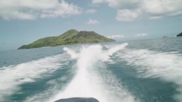 离开热带岛屿的Pov 带着高速汽艇在海面上飞溅 带着完美的蓝天和云彩从绿岛出发 从观点出发 白色泡沫痕迹 完美假期 — 图库视频影像