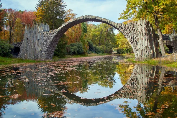 Stone arch bridge Kromlau, made of basalt stones, saxony, Germany, called Rakotz Bridge or devils bridge, upright photo