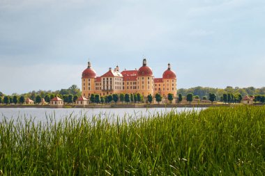 Moritzburg Castle, photo taken from the northwest over the castle lake, in beautiful summer weather, blue sky and light clouds, Moritzburg, Saxony, German clipart