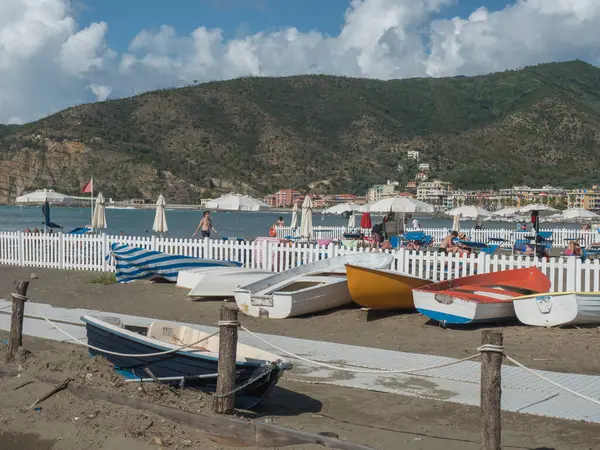 stock image Sestri Levante, Liguria, Italy, September 23, 2023: Seaside with colorful wooden fishing boats and people sunbathing at sand beach Bagni Liguria at Sestri Levante, Italy Europe.