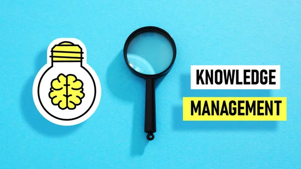 Knowledge Management is shown using a text and photo of magnifying glass and picture of light bulb with brain