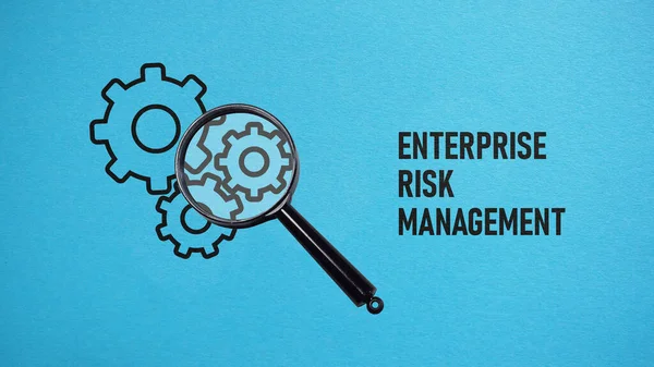 Enterprise Risk Management ERM is shown using a text and photo of magnifying glass and picture of gears