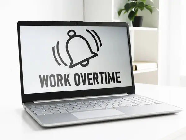 Work Overtime is shown using a text on the laptop and picture of the bell of alarm clock