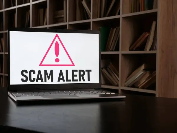 Beware of scams or scam alert is shown using a text on the screen of laptop