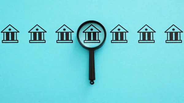 stock image Bank research. Magnifying glass and the bank. Interest rates, investment opportunities, and regulatory changes. Valuable insights into financial products and services