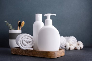 White empty shampoo or lotion bottle for mock-up in modern dark bathroom interior clipart