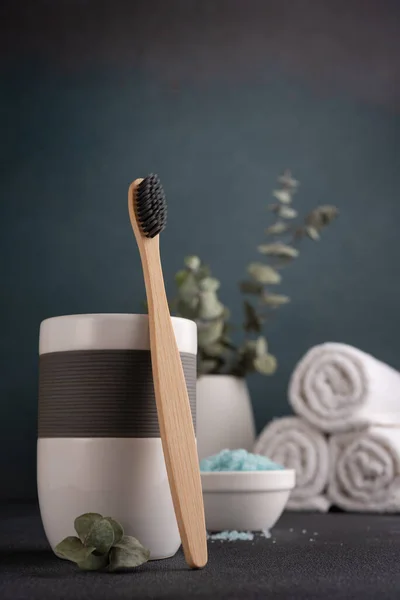 Bamboo toothbrush, towels and other bathroom accessories. Wellness and spa concept.