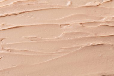 Tonal yüz kreminin bej lekeli dokusu. Makyaj ve cilt bakımı için makyaj ürünleri. 