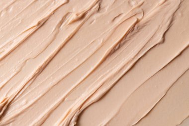 Tonal yüz kreminin bej lekeli dokusu. Makyaj ve cilt bakımı için makyaj ürünleri. 