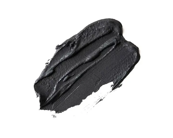 在白色背景上分离的化妆品黑色黏土的污迹 用于痤疮治疗 皮肤科的黏液中风 图库图片