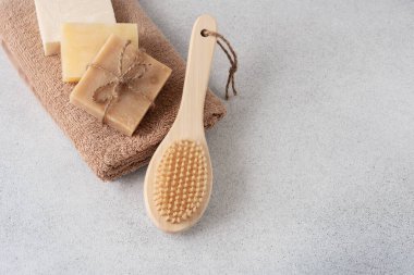 El yapımı sabunlar, havlu ve ahşap masaj fırçası. Vücut bakımı ve sağlık konsepti.