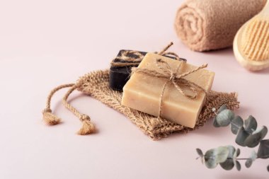 Organik sabun barları, jüt bezi, havlu ve ahşap arka fırça. Doğal ve sıfır atık banyo ve kişisel bakım kavramı.