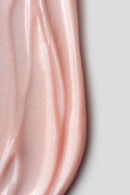 Pembe incili tırnak jölesi yakın plan. Parlatıcı ve parlak. Manikür, tırnak sanatı, kozmetik tasarım veya güzellik markası için ideal doku arka planı.