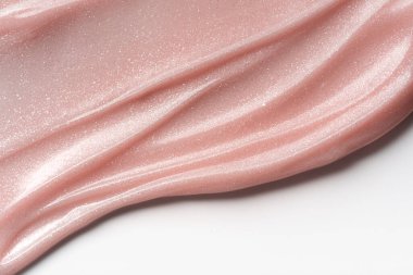 Pembe incili tırnak jölesi yakın plan. Parlatıcı ve parlak. Manikür, tırnak sanatı, kozmetik tasarım veya güzellik markası için ideal doku arka planı.