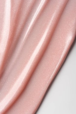 Pembe incili tırnak jölesi yakın plan. Parlatıcı ve parlak. Manikür, tırnak sanatı, kozmetik tasarım veya güzellik markası için ideal doku arka planı.