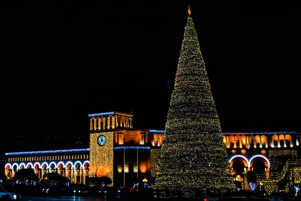 stock image New Year's huge tree and city lights. New Year tree in Yerevan, Armenia. Glowing building