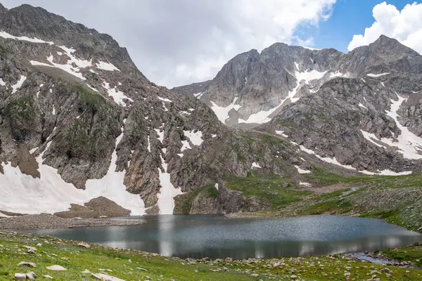 高山湖泊和岩石山 岩石中间的水晶清澈的湖面 湖泊和雪地下的山脉 — 图库照片