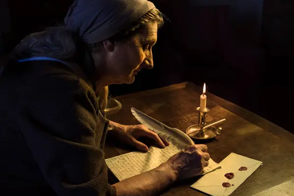 Lady in medieval costume writing a letter with a feather quill