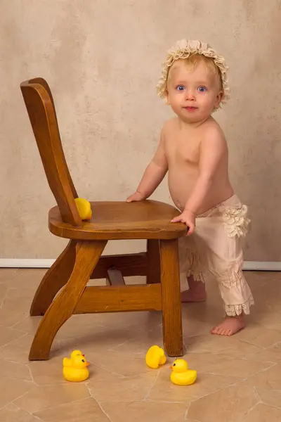 Baby Boy Months Old Holding His Balance Wooden Chair Trying lizenzfreie Stockbilder