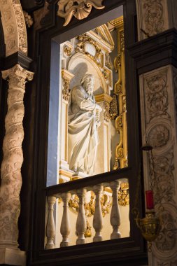 Beautifully lit marble statues in the baroque Carolus Borromeus church in the heart of the city of Antwerp in Belgium clipart