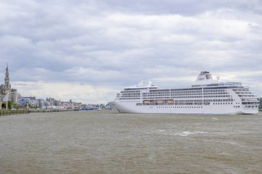 Antwerp, Belgium, July 7th 2024: Illustrative Editorial: Regent Seven Seas Cruise ship mooring in Antwerp on Scheldt River clipart