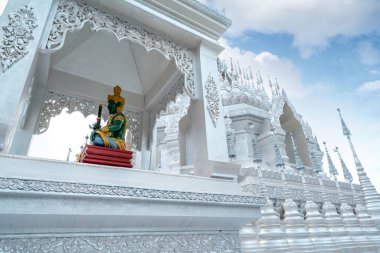 The white pagoda of Prajna Temple in Xishuangbanna, Yunnan, China. clipart