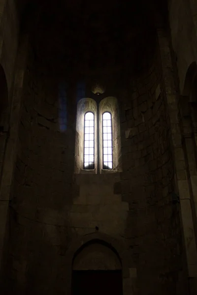 view of the church vault and the window in the old church, in an entourage dark environment in natural light