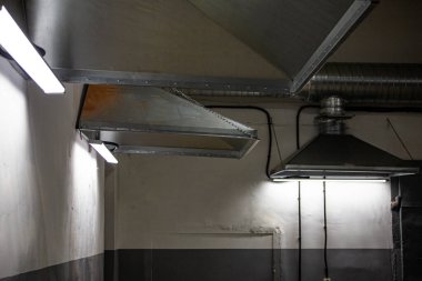 close-up of exhaust hoods in hazardous production, together with an air removal system, photographed immediately after installation work