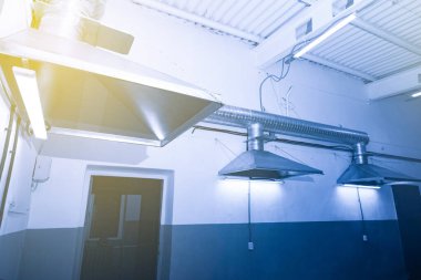 close-up of exhaust hoods in hazardous production, together with an air removal system, photographed immediately after installation work