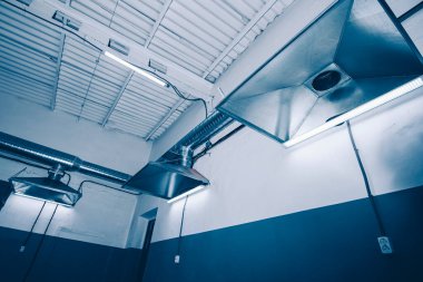 close-up of exhaust hoods in hazardous production, together with an air removal system, photographed immediately after installation work