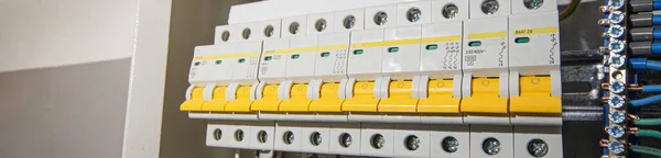 Switchboard equipment. Shield for enterprise electrification. Switchboard for control over electrical equipment. Labeled panel with wires and switches at the enterprise