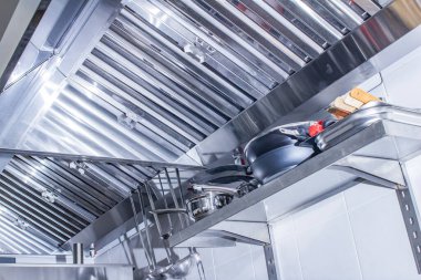 professional hood in a restaurant kitchen made of stainless steel with galvanized duct clipart