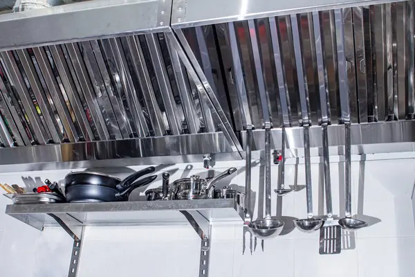 professional hood in a restaurant kitchen made of stainless steel with galvanized duct