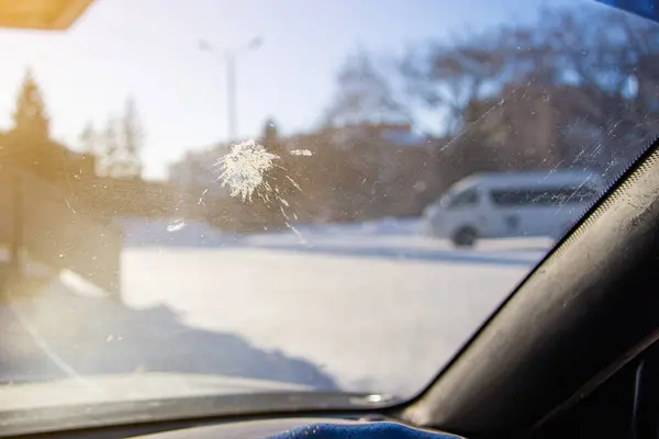 Bird droppings on the windshield of a car. The windshield of the car stained with bird excrement. It\'s an unpleasant situation. Selective focus