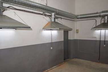 close-up of exhaust hoods in hazardous production, together with an air removal system, photographed immediately after installation work