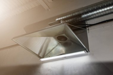 close-up of exhaust hoods in hazardous production, together with an air removal system, photographed immediately after installation work