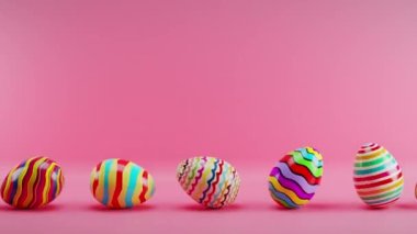 Multicolored Easter eggs rolling on a red background. Loop animation.