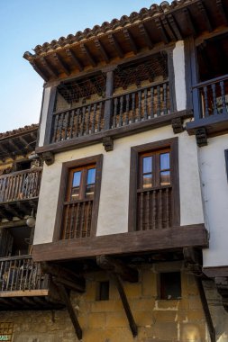 İspanya 'nın Santillana del Mar kentindeki tarihi bir binanın kırsal ahşap balkonuna yakın çekim. Büyüleyici mimari ayrıntılar bölgenin kültür mirasını vurguluyor