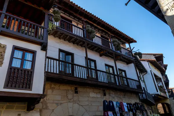 stock image Close-up of a rustic wooden balcony on a historic building in Santillana del Mar, Spain. The charming architectural details highlight the region's cultural heritage