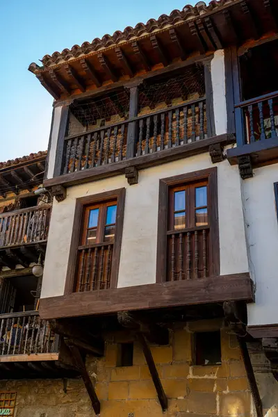 stock image Close-up of a rustic wooden balcony on a historic building in Santillana del Mar, Spain. The charming architectural details highlight the region's cultural heritage