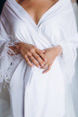 Bride's hands with the wedding ring. Bride preparation concept. High quality photo