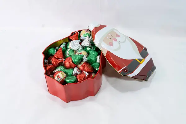 İçinde çikolatalı şeker olan Noel Baba şeklinde bir teneke kutu..