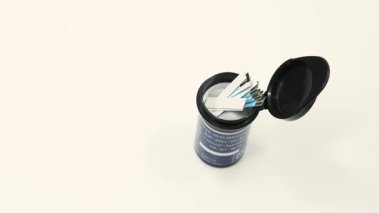 Glikoz test şeritlerinin açık bir kabı saat yönünde dönüyor.