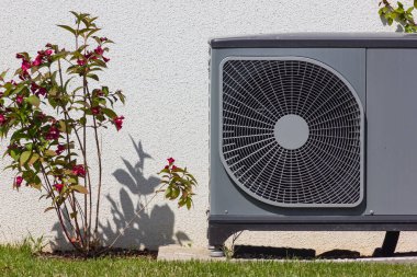 heat pump in a new building area with modern house facades of south germany on a sunny day in springtime clipart