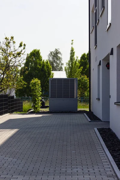 heat pump in a new building area with modern house facades of south germany on a sunny day in springtime